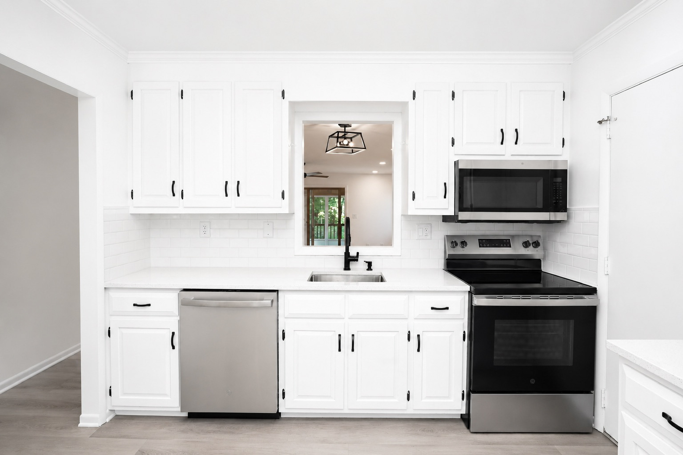 Renovated white kitchen with marble countertops and black hardware — a Cash 4 Houses CT flip